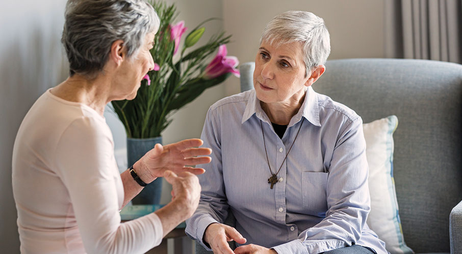 Elderly woman talking with a pastoral care worker