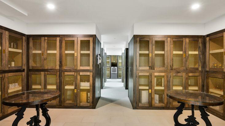 Tiled room with wooden framed transparent wine lockers