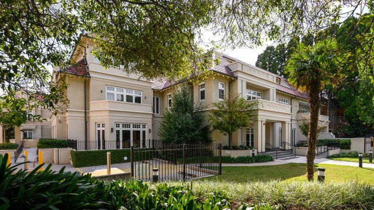 Ecru coloured multi story building with lawn in front