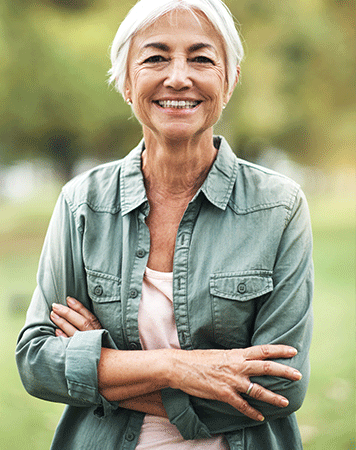 Woman smiles to camera with arms crossed