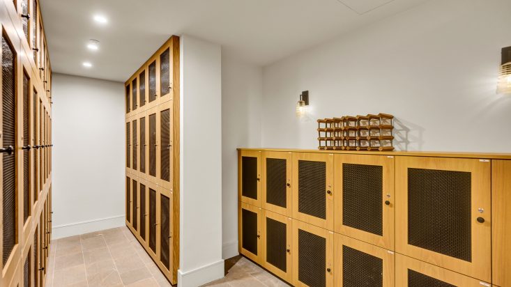 Room with wood coloured lockers to store wine