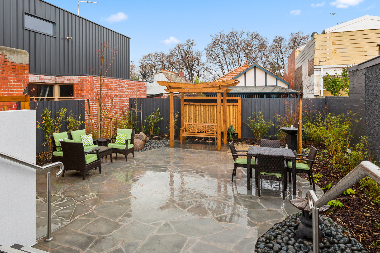 Courtyard after it had just rained with pergola