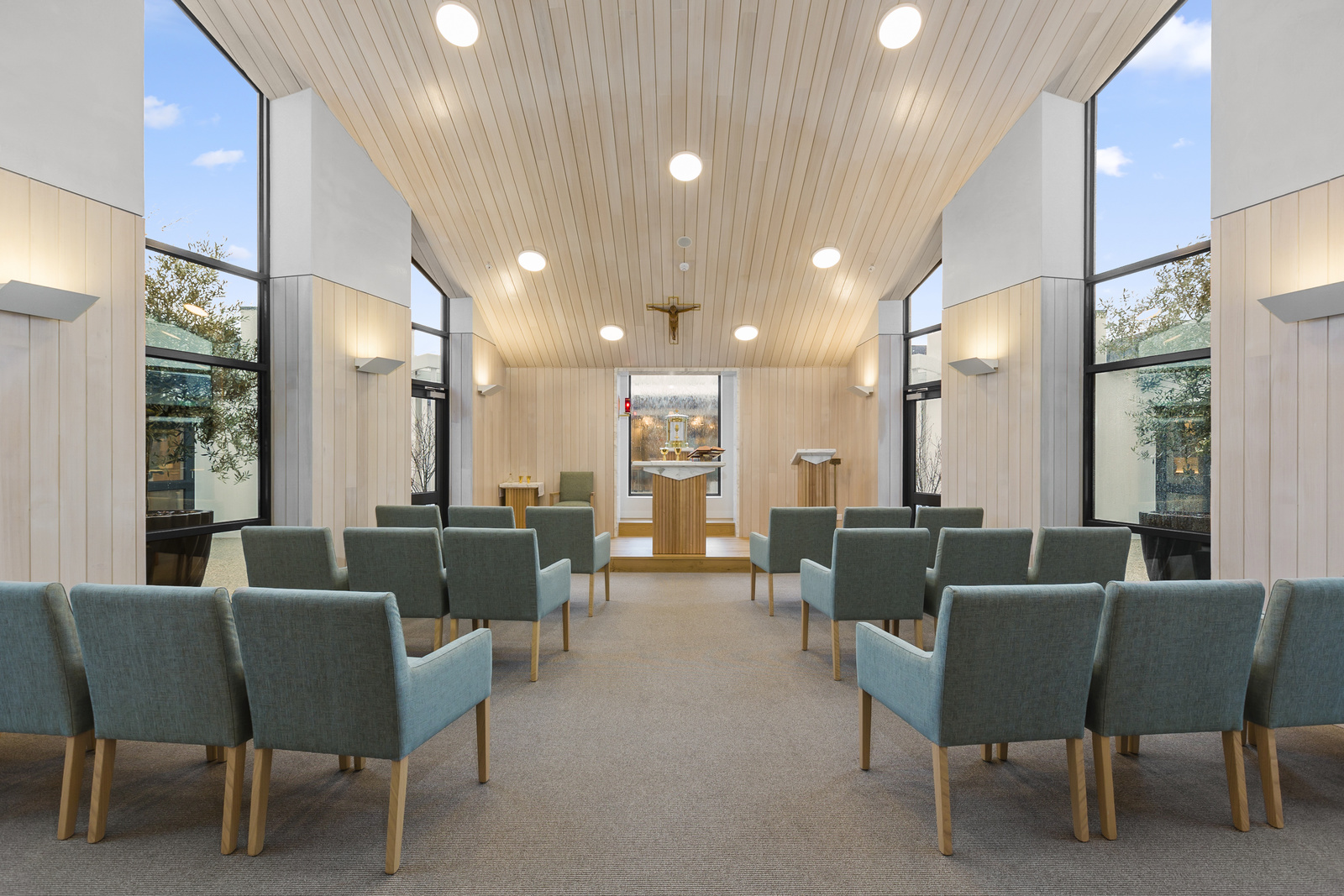 Chapel with high ceiling and rows of comfortable chairs