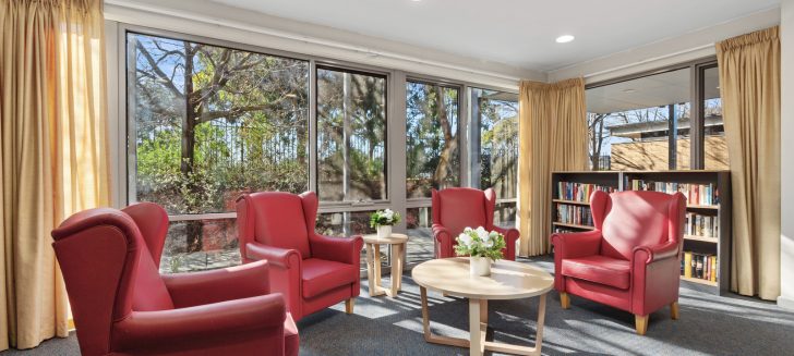 Sunlit lounge room with armchairs