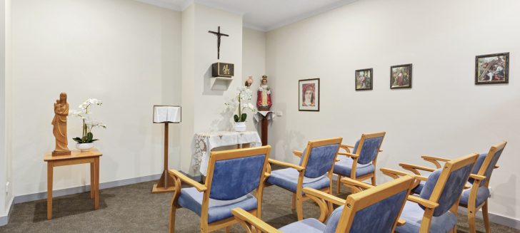 Chapel with rows of cushioned chairs