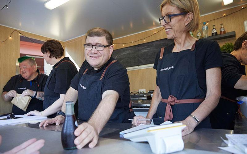 Photo of people serving drinks