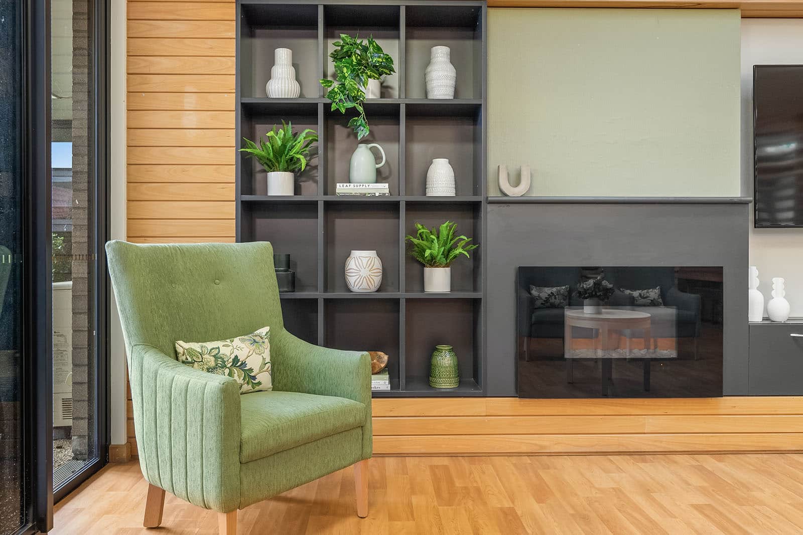 Foyer with green armchair and fireplace