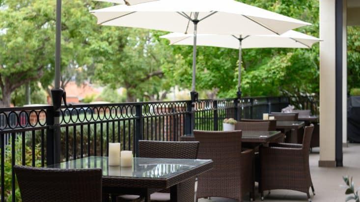 Umbrellas over outdoor dining tables