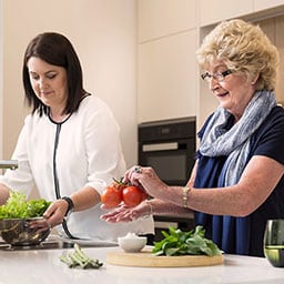 Two women cooking dinner