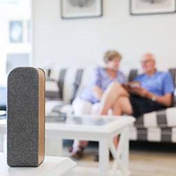 Speaker in foreground and blurred out couple in the background