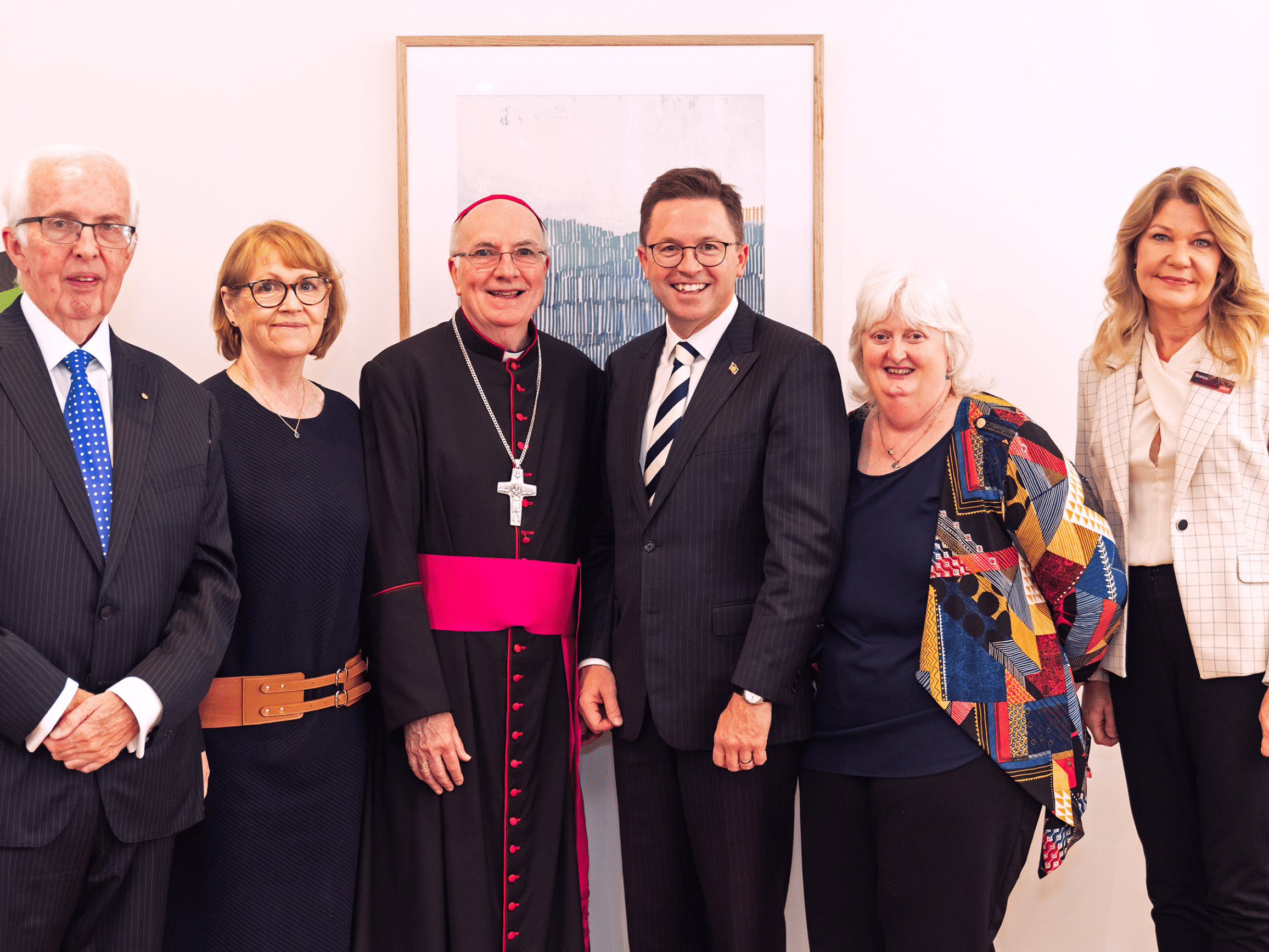 Three men and three women smile for camera