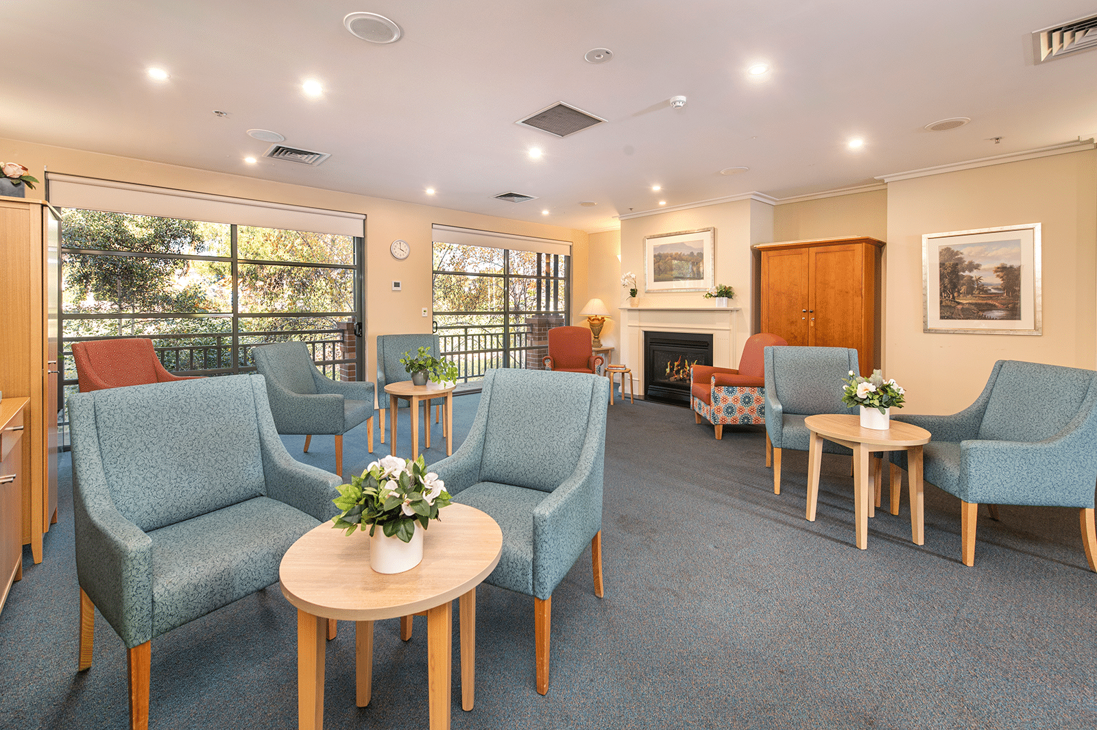 Living room with fireplace and multiple sets of armchairs