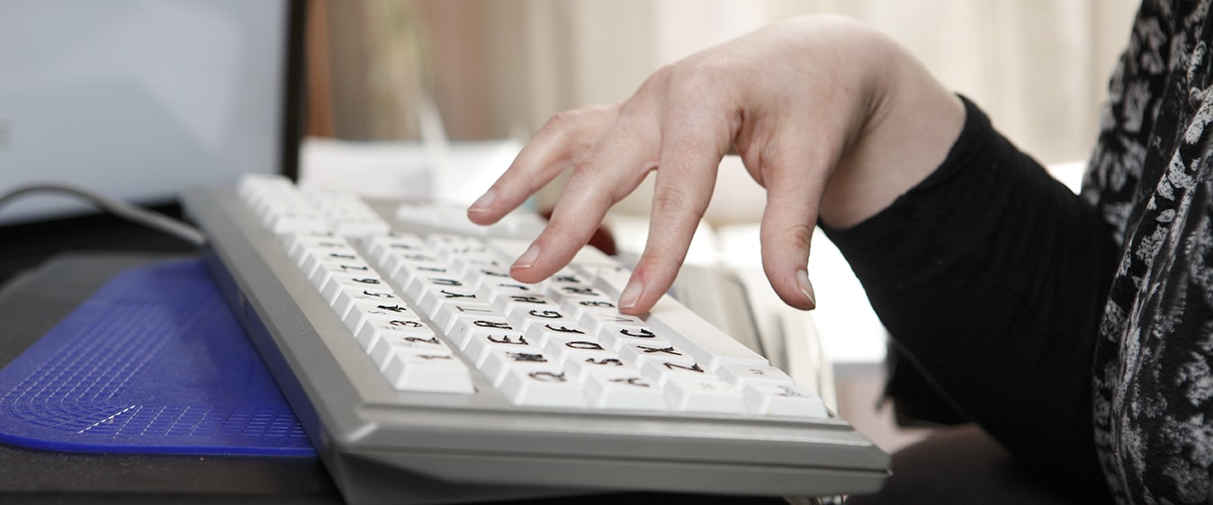 A hand using a keyboard