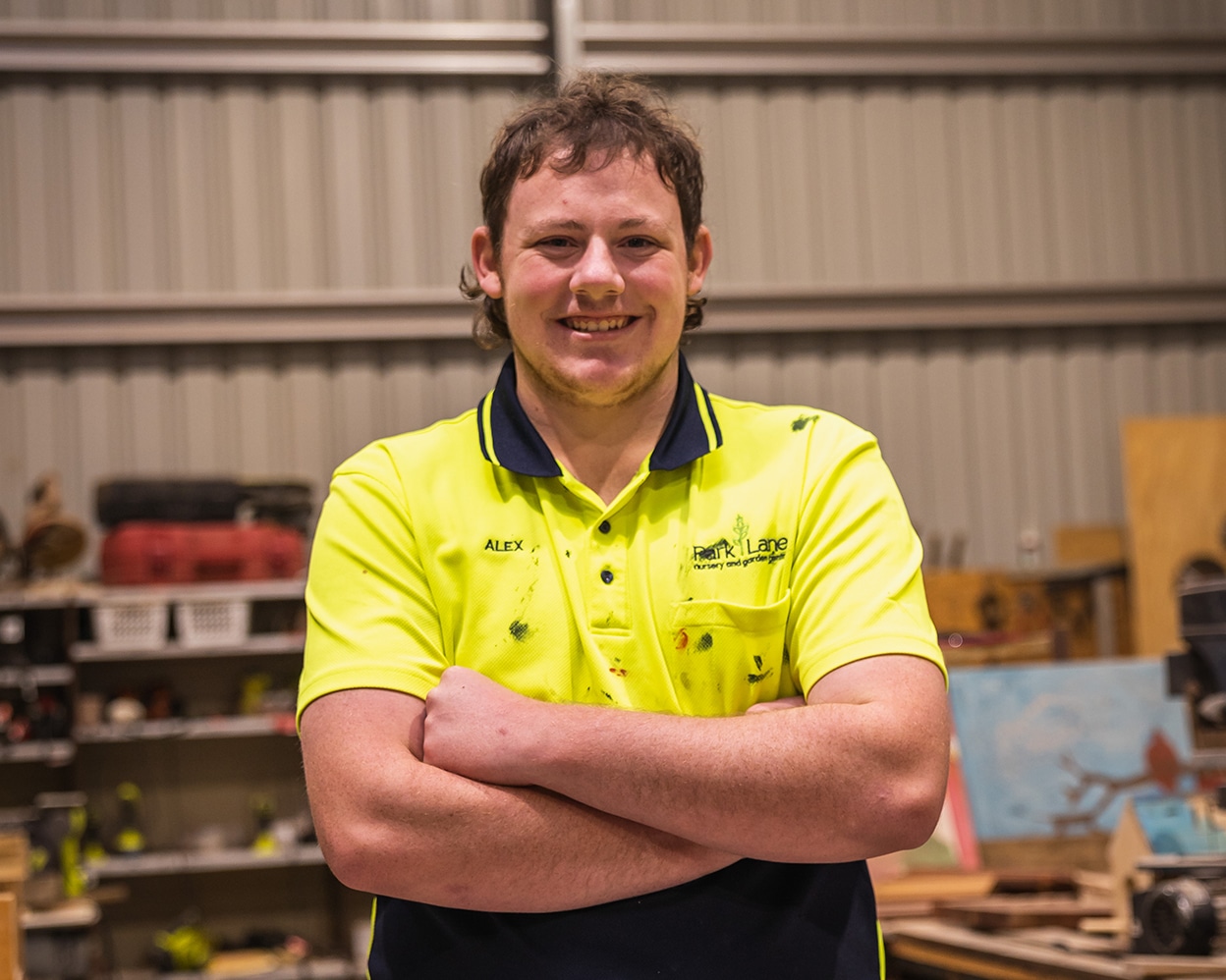 Man in a workshop, smiling