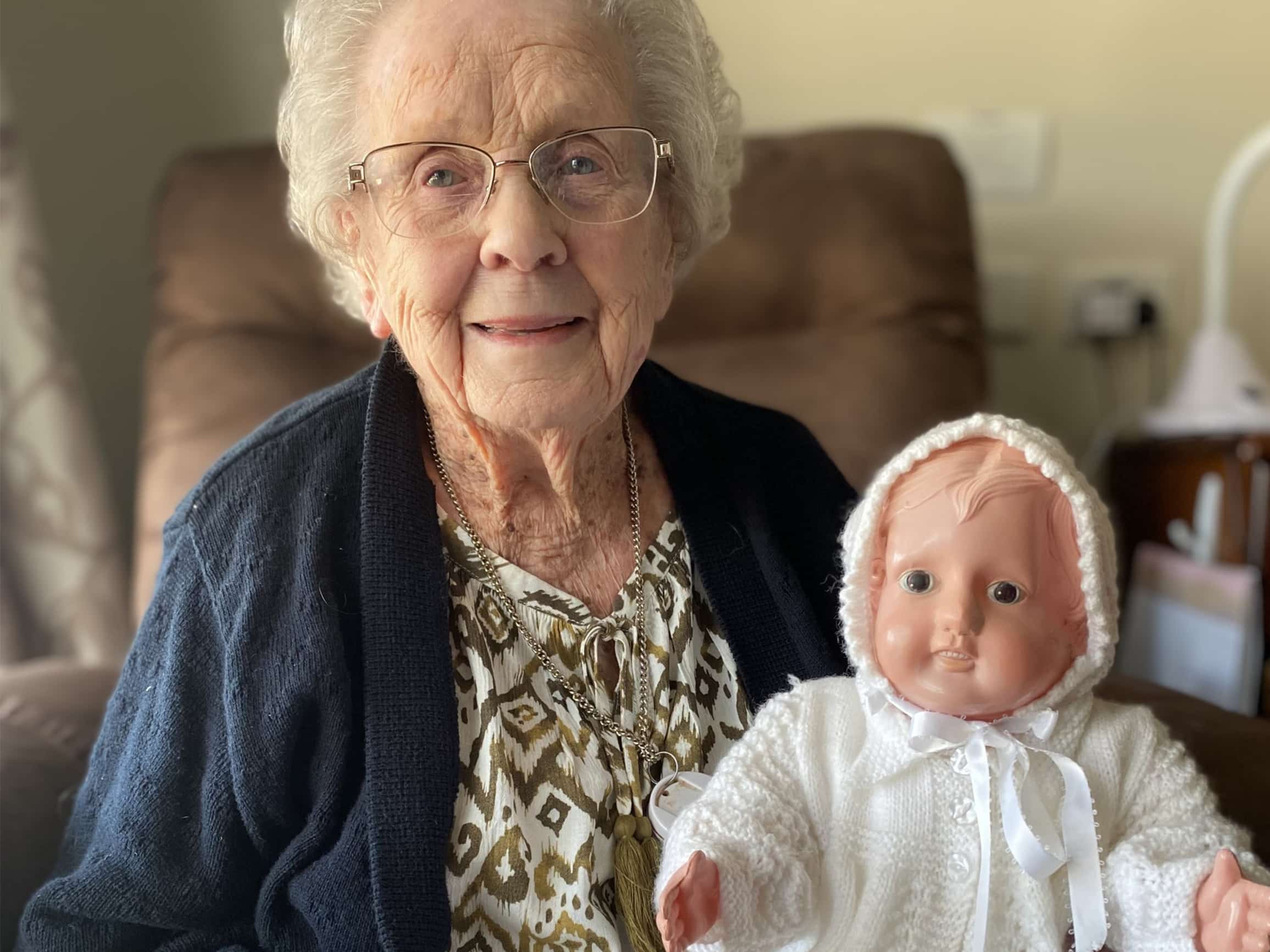 An older lady with a doll