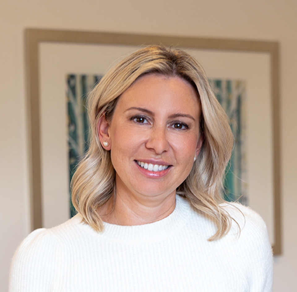 A blonde woman smiling at the camera