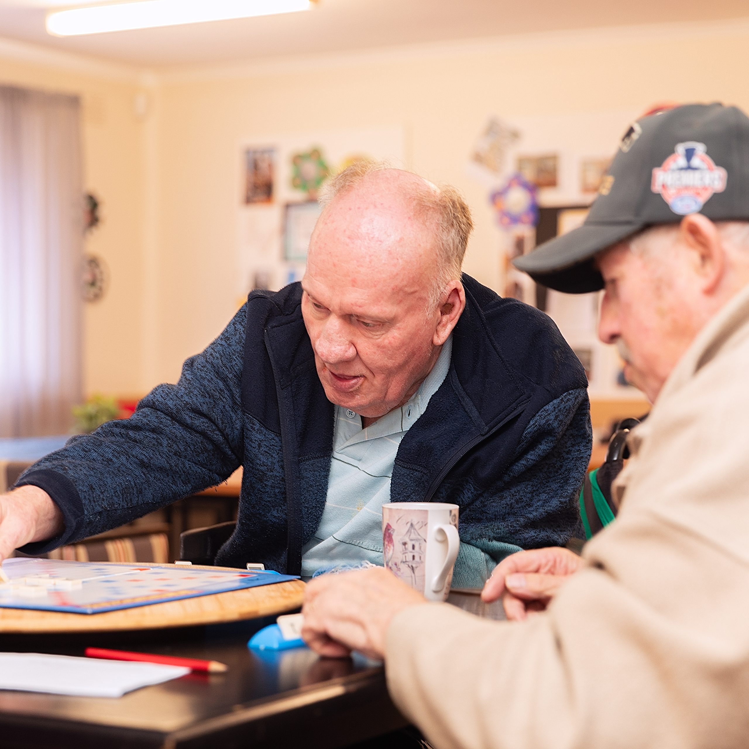 Two older men playing scrabble