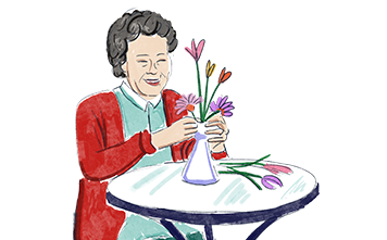 A woman organising a floral arrangement