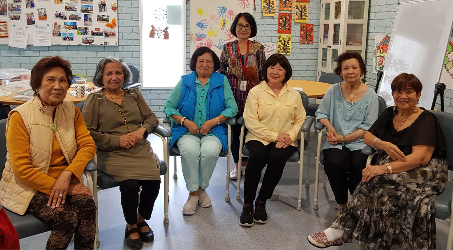 A group of women at the Filipino Community Group sitting in a classroom