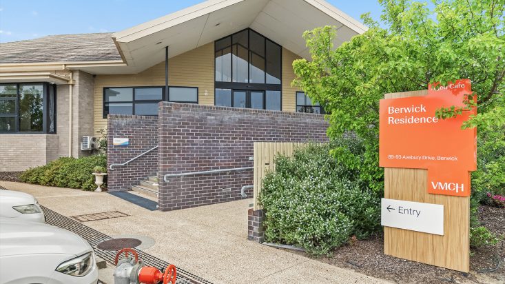 Berwick Aged Care front building with a pointed roof. Stairs lead up to entrance and are partially blocked by a wall with rail supports.