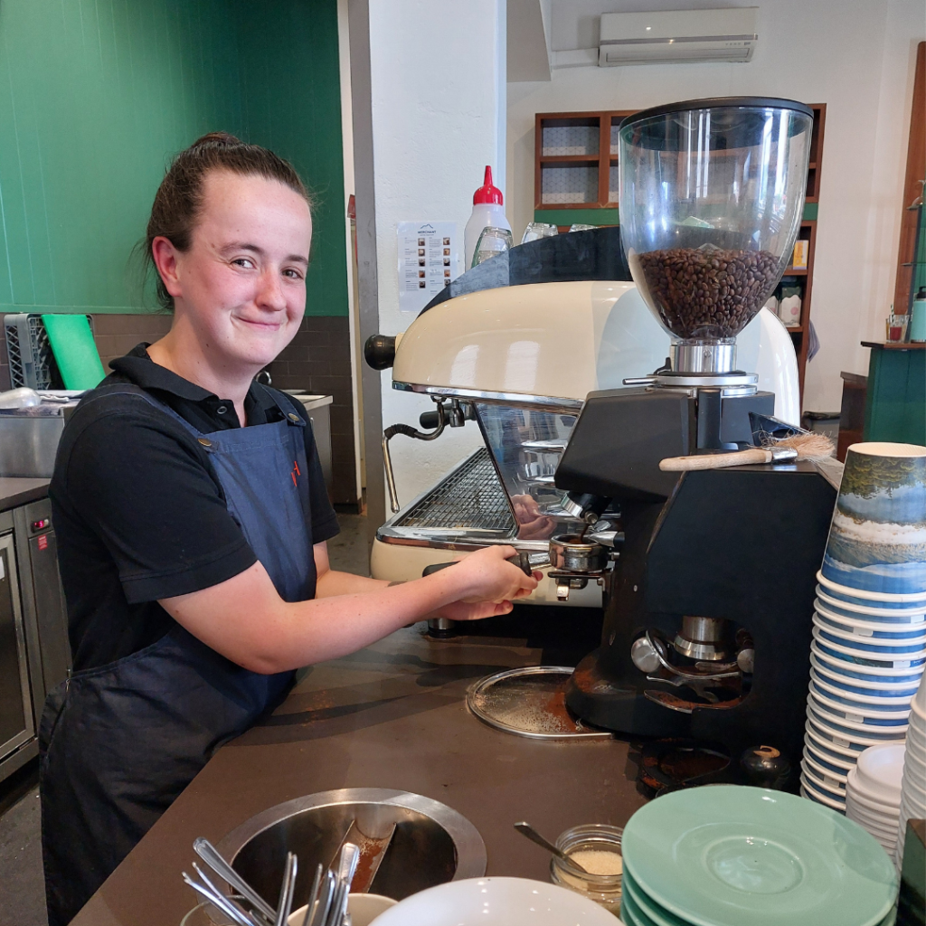 A young woman makes a coffee