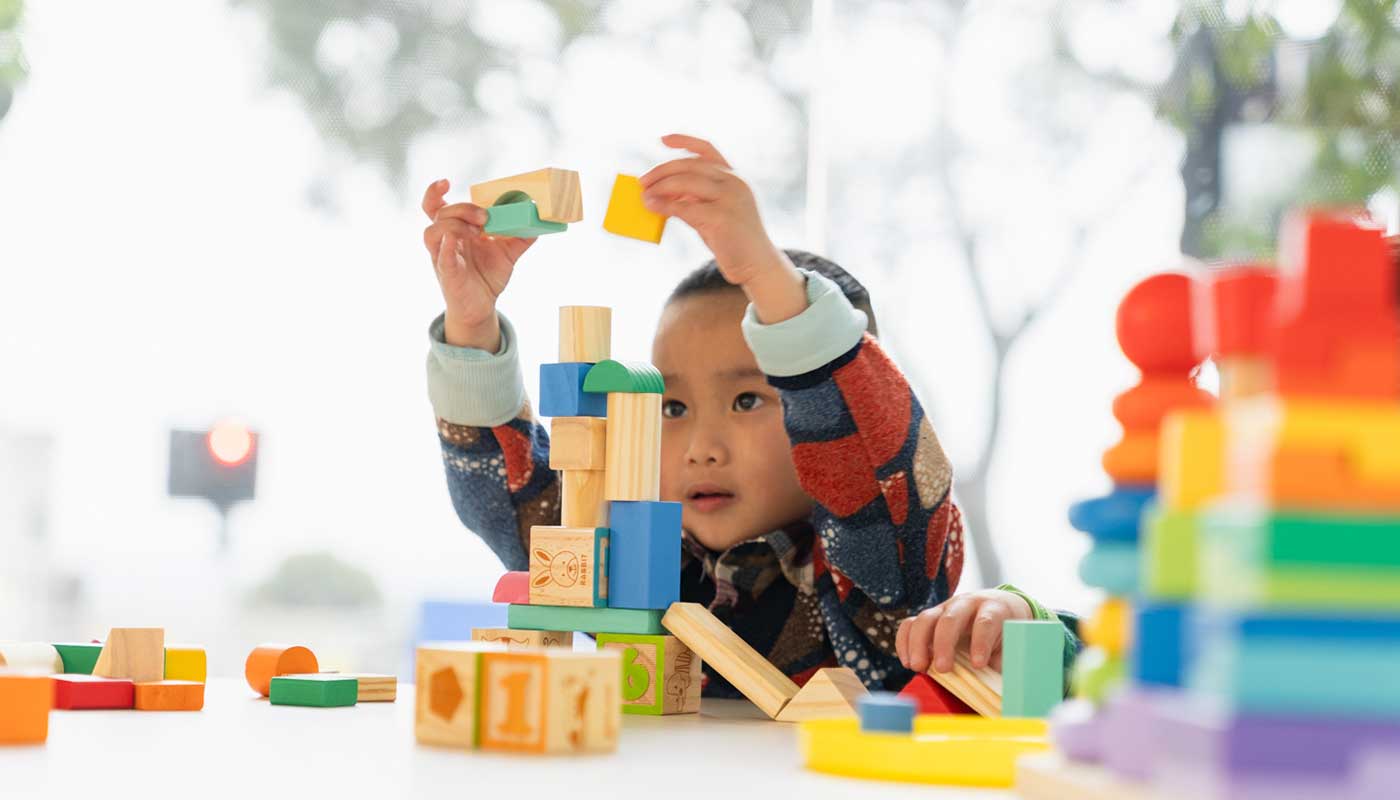 A young boy playing with building blocks