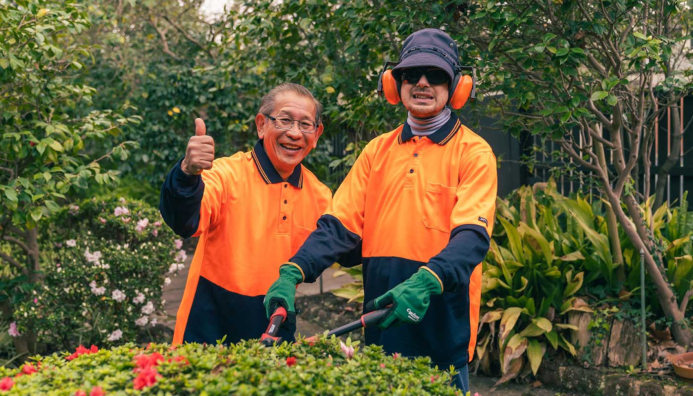 A male client and his support worker gardening