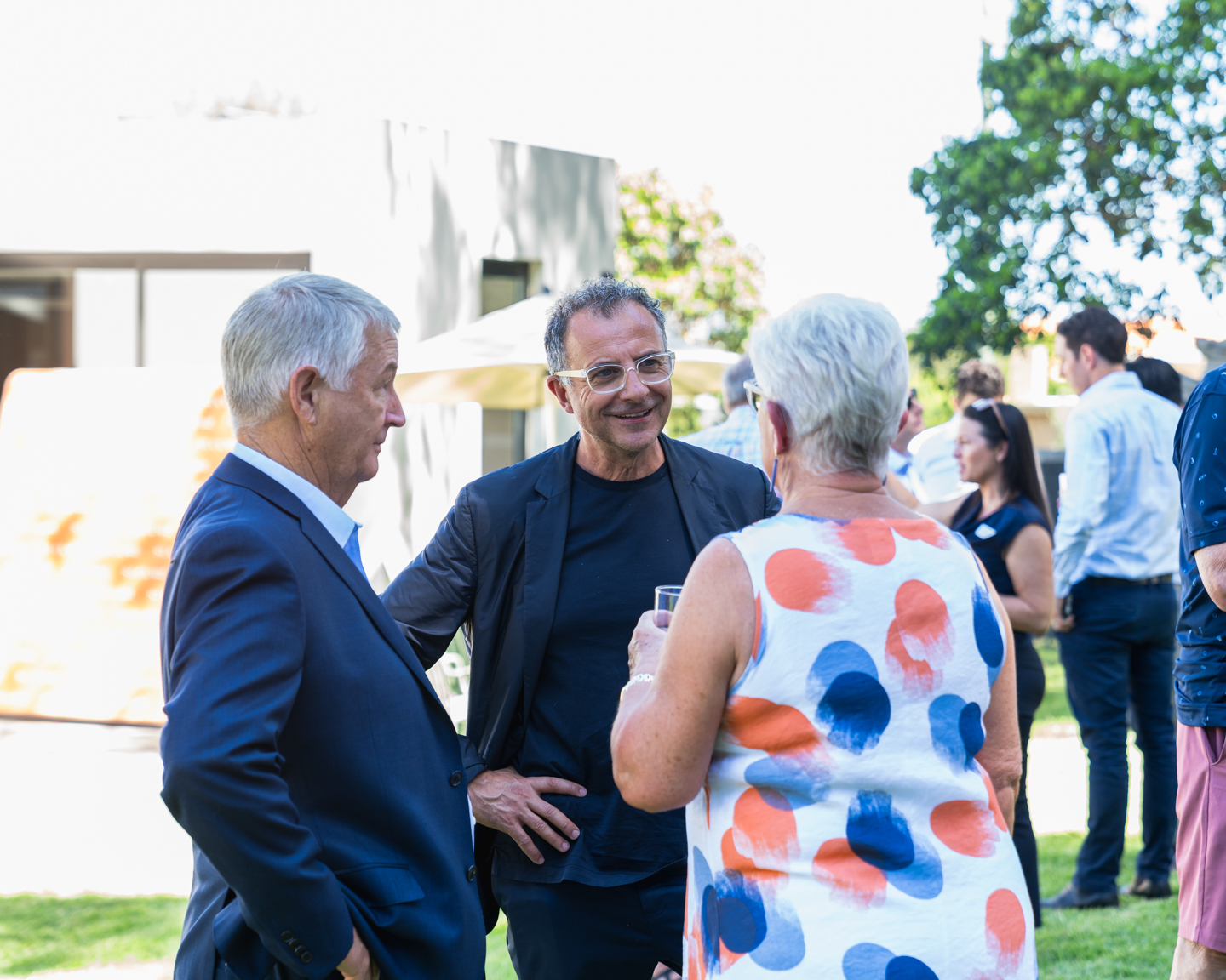 Two men and a woman chat