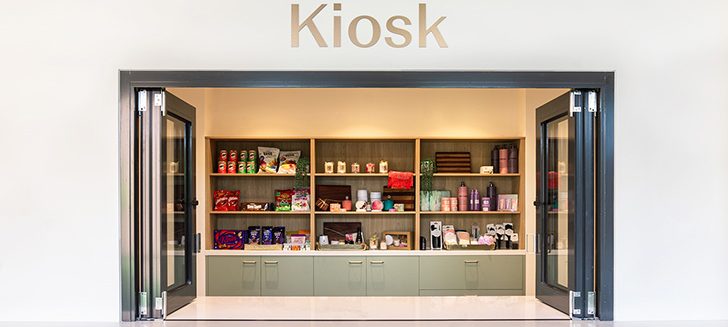 A kiosk bench with the windows open and shelves behind stocked with treats.