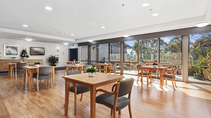 A large dining room with many tables.