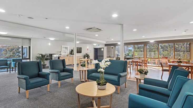 A large dining room with blue armchairs.