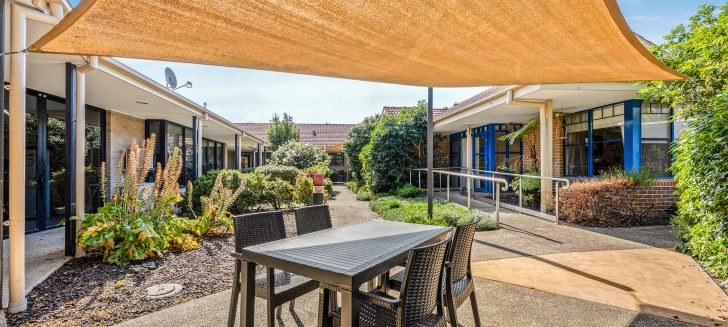 Berwick Aged Care deck overlooking grass and trees.
