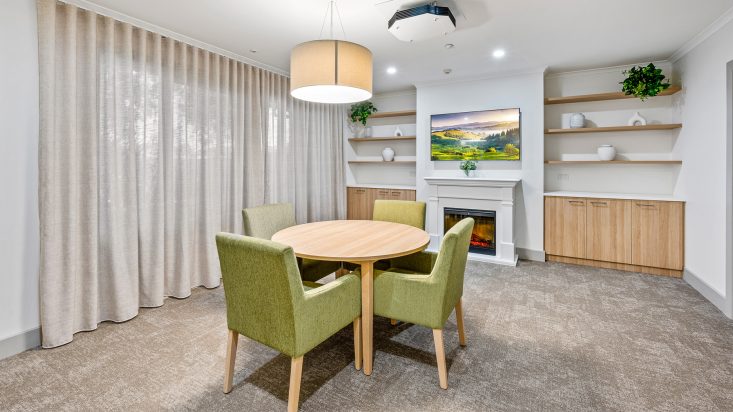 A living room with green furniture.
