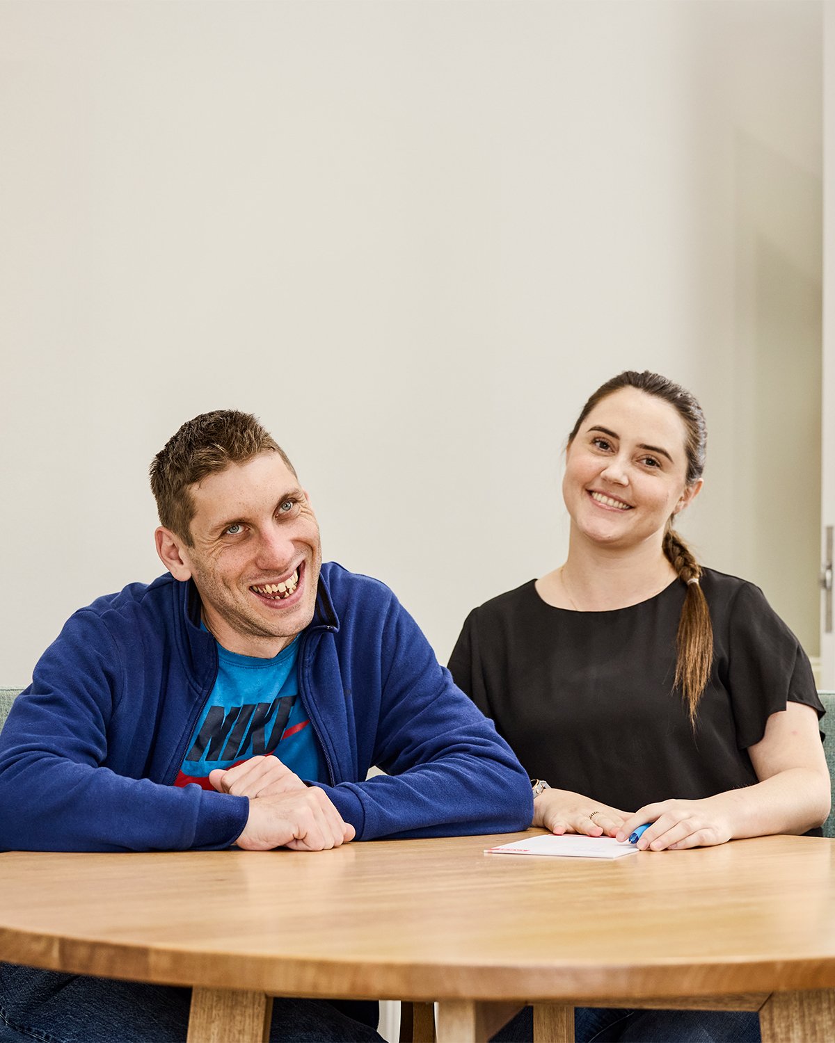 A man and woman sitting at a round table.