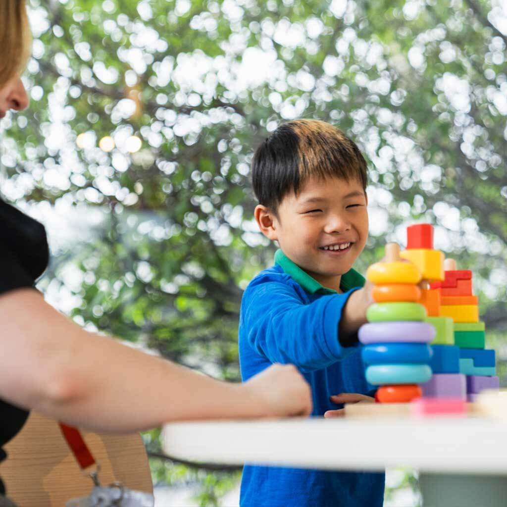 A child playing with colourful blocks.