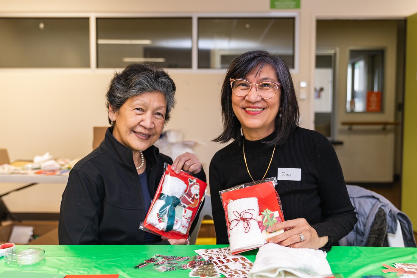 Two women hold handmade cards