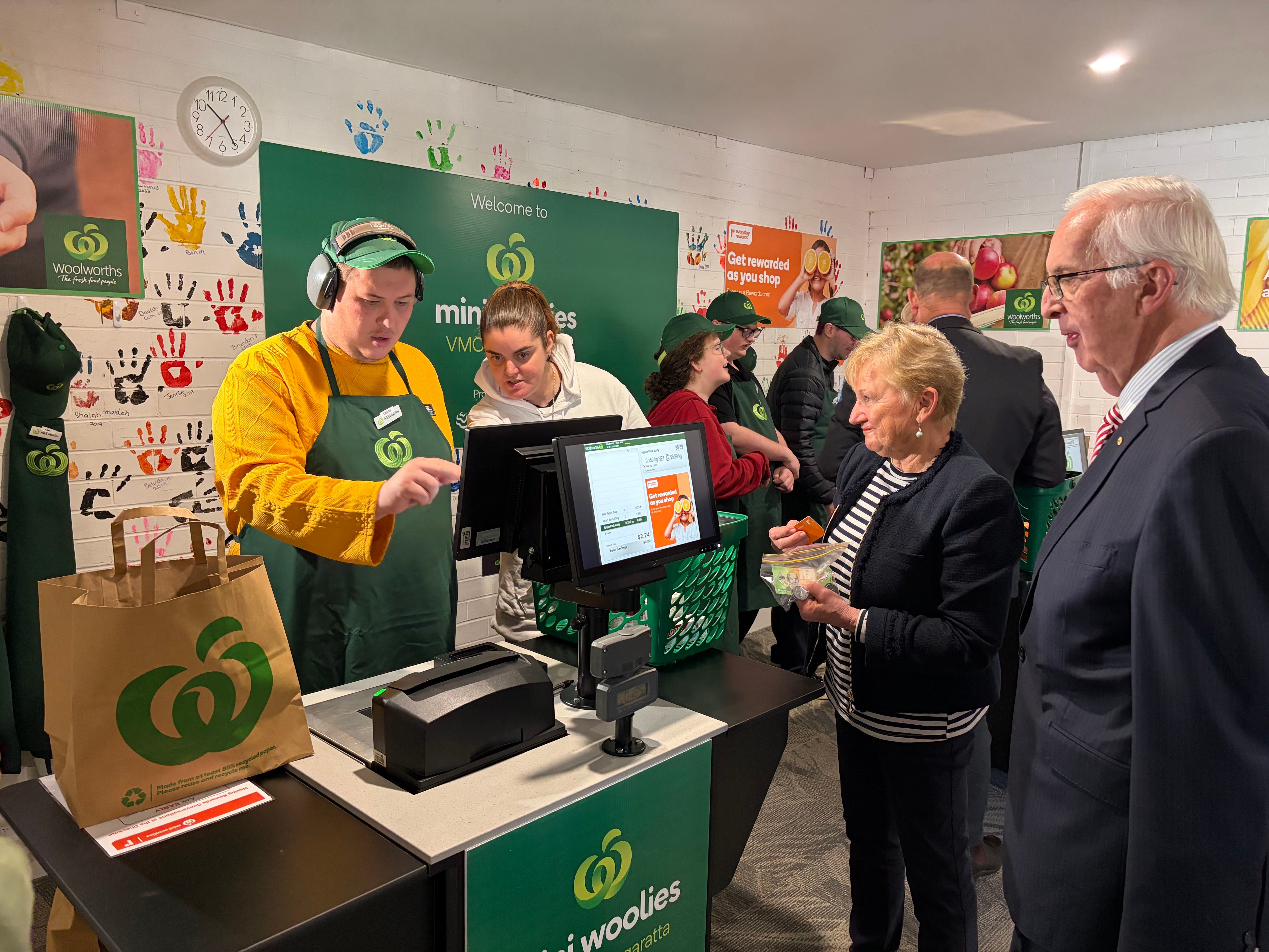 VMCH participant Travis serves Wangaratta Lord Mayor Irene Grant and VMCH Board Chairman Julien OConnell AO