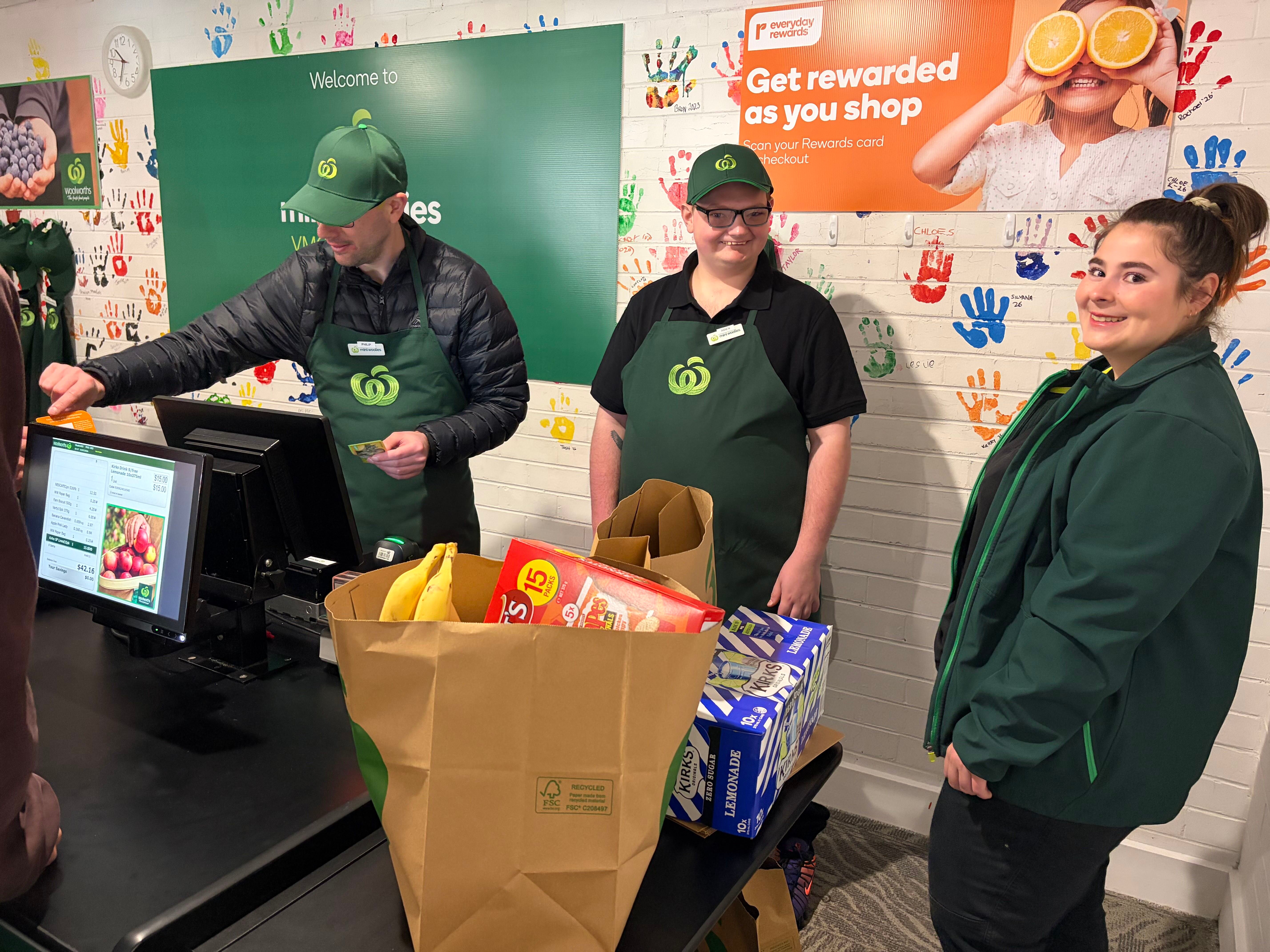 VMCH participants Philip and Aiden chat with Wangaratta Woolies employee Abbey