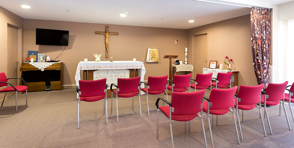 Chapel with rows of red chairs