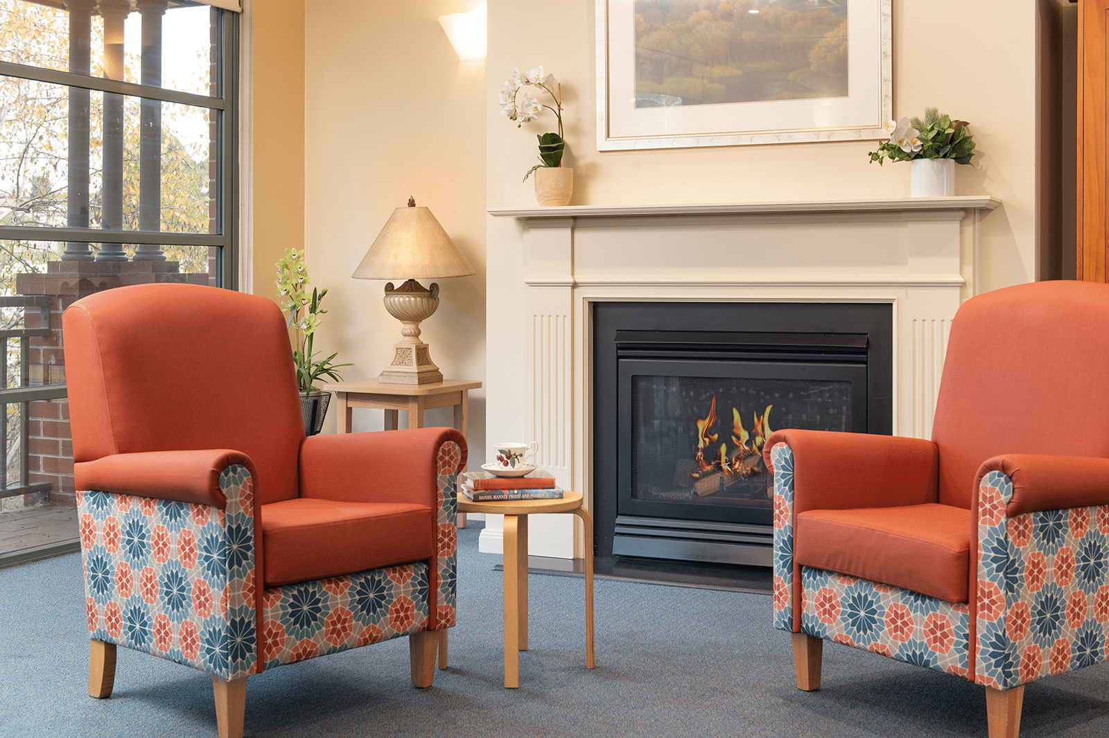 Two armchairs in a living room in front of a electric fire